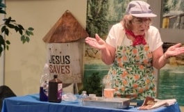 VBS leader and children engaged in interactive Bible story play acting