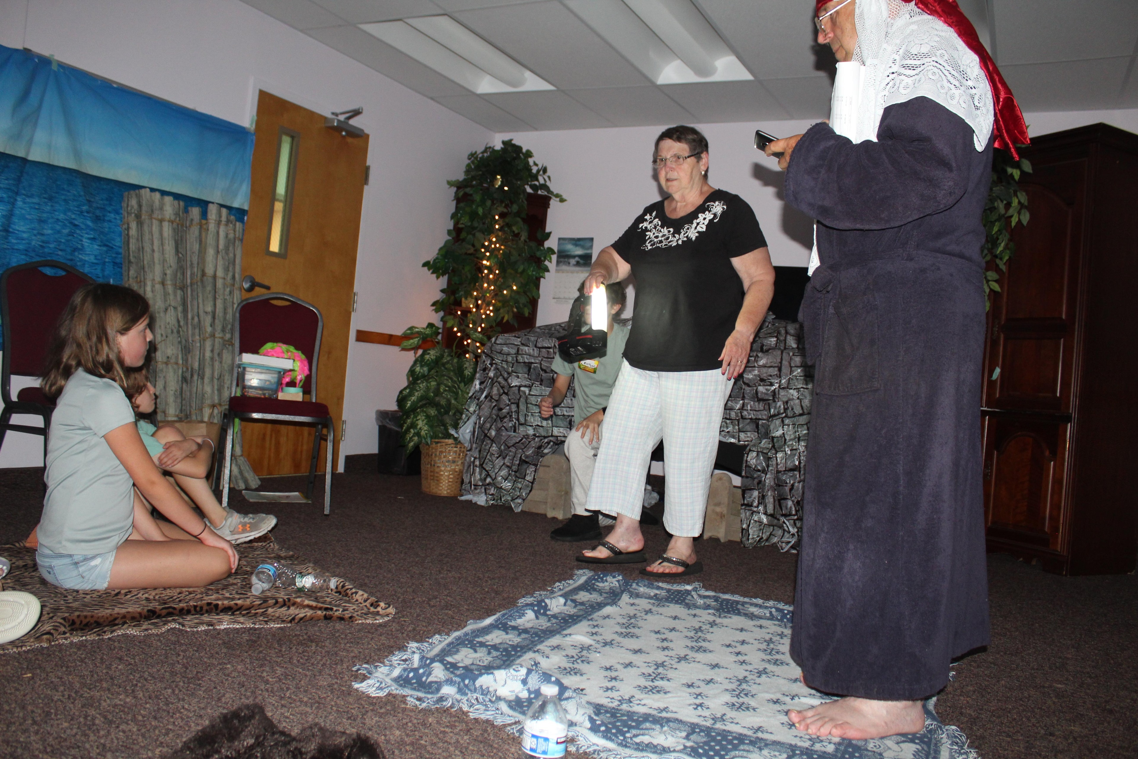 VBS leaders and kids acting out a Bible story in costume