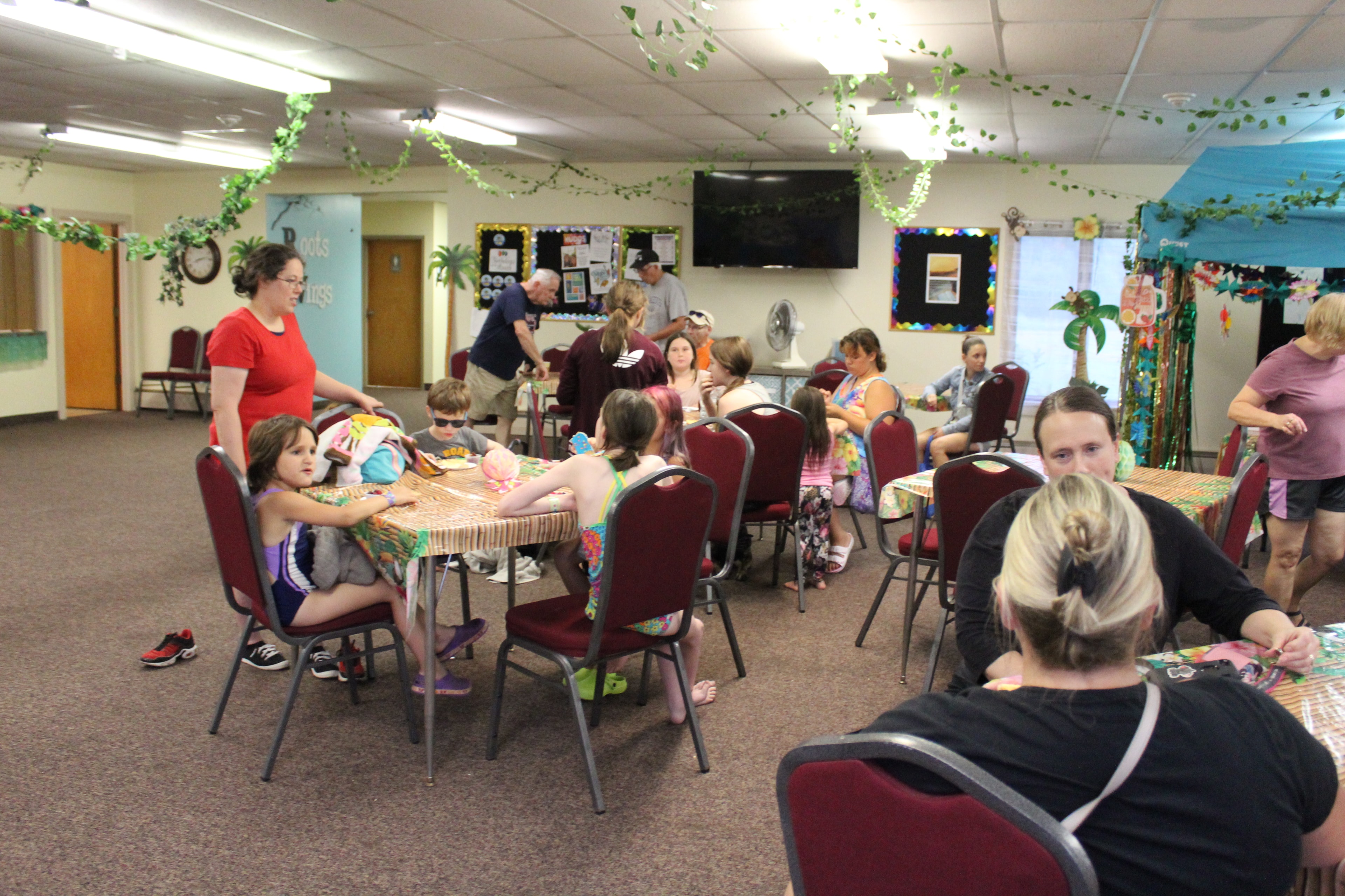 Parents and families gathered around tables at Discovery Church VBS